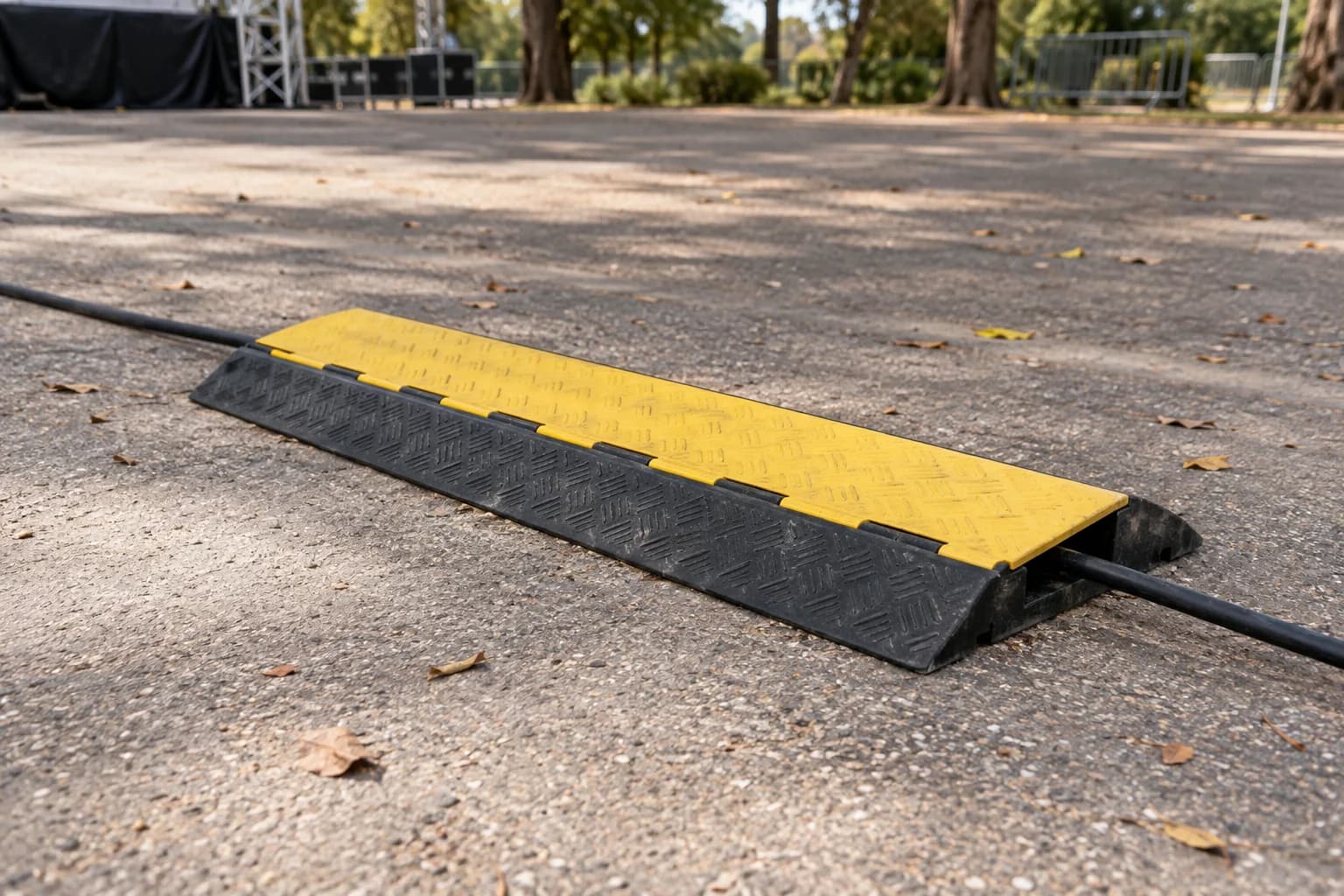 A closed generic cable ramp across an empty dry outdoor path. AI-generated editorial illustration; not a photograph of a tested product or a verified model.